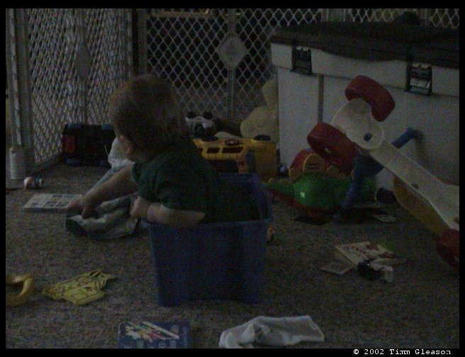 Logan surrounded by toys.