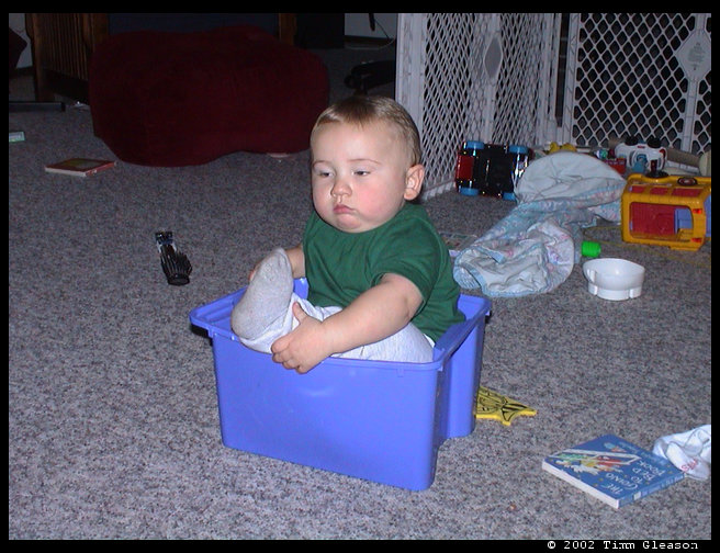 Logan is in this tub that holds his blocks usually.