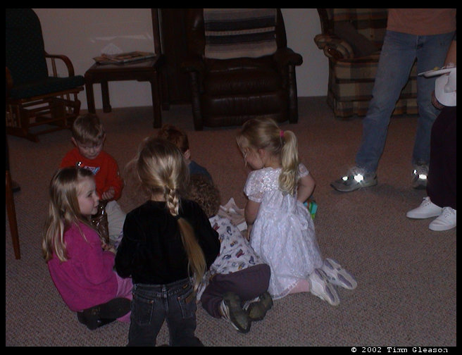 All the kids want to help with presents.