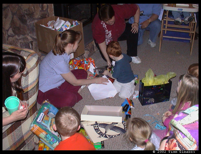 Kristi helping Walt open more presents.