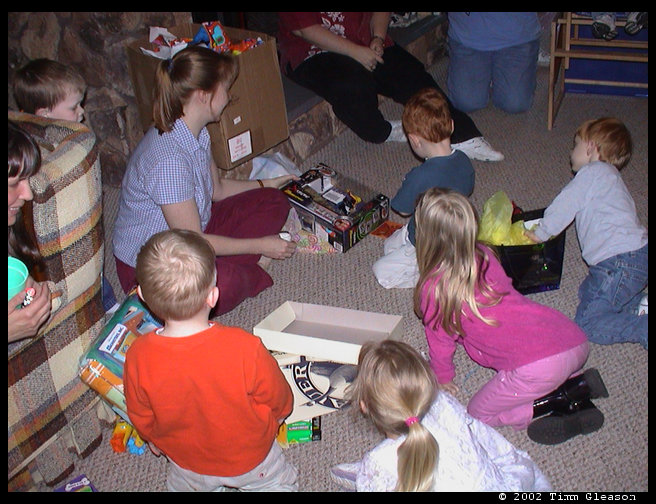 Kristi (mom) helping Walt open his presents.