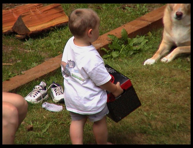 Logan carrying a full half case of lemonade.  