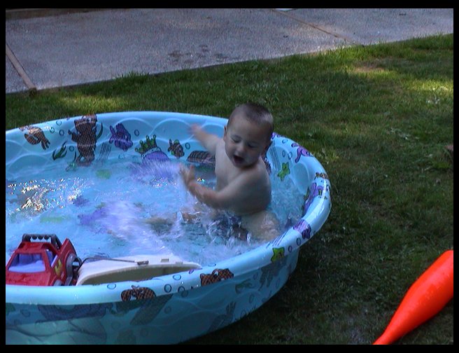 Our little boy in his wading pool.