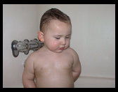 Logan standing up in the bath tub..which he isn't suppose to be doing.