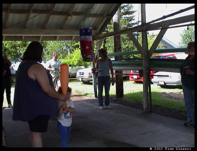 Helping Maddie break the pinata open.  