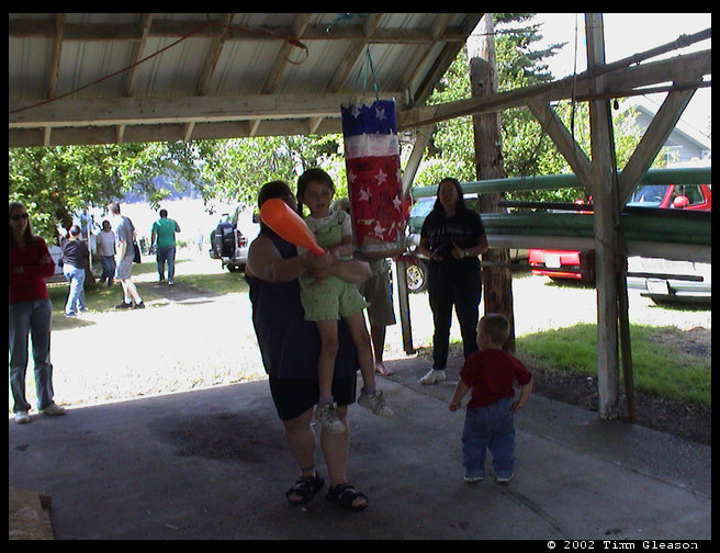 Helping Rebecca break the pinata open.