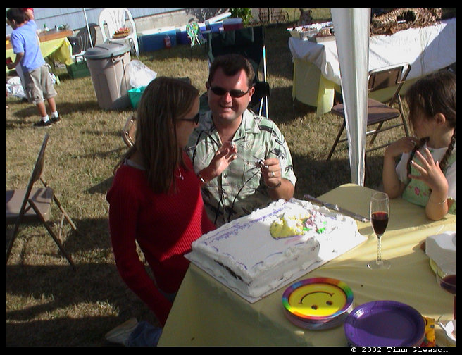 Jeff with a piece of cake to feed to Heather.