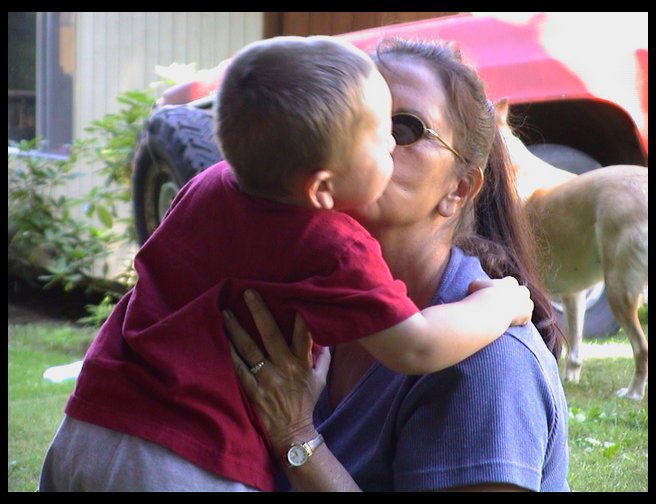 Logan getting kisses from Grandma Zoe