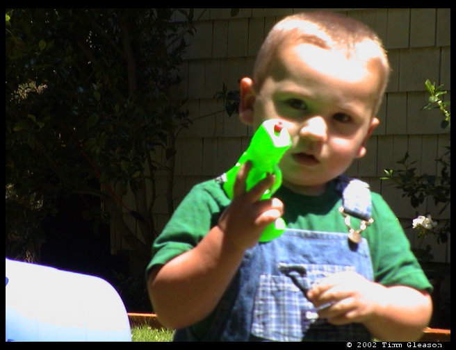 Logan posing with squirt gun. 