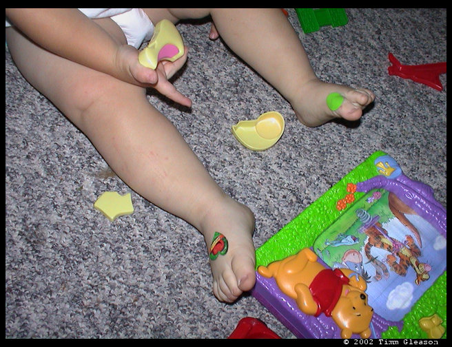 Thought this was a cute pic.  Logan has an owie on his left foot (lime green band aid) but he went and found a sticker for the other foot.  