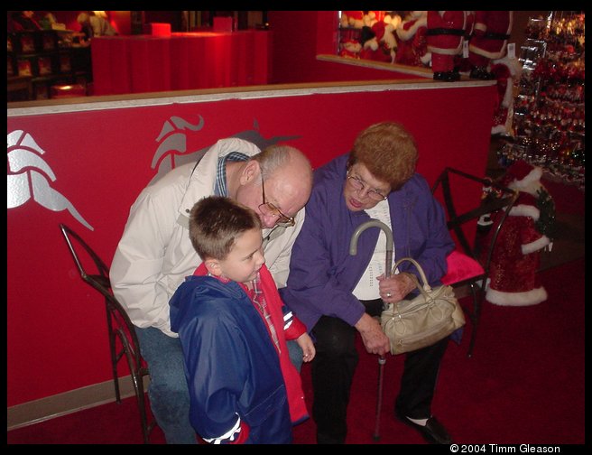 Grandma and Grandpa Trogdon waiting with Logan to see Santa