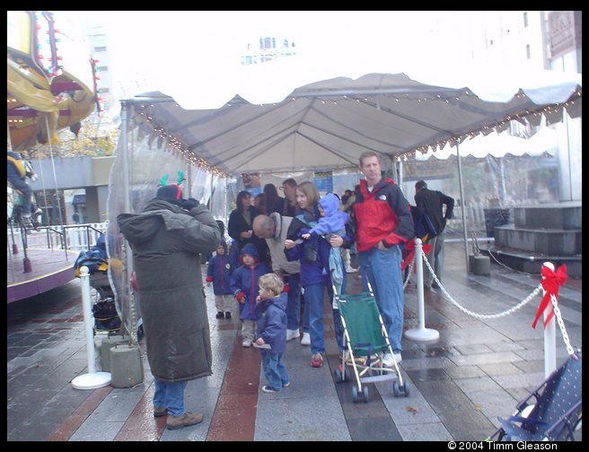 Grandpa and Logan waiting in line for the Carousel 