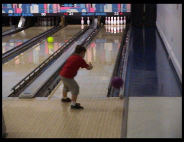 Logan bowling at his party.